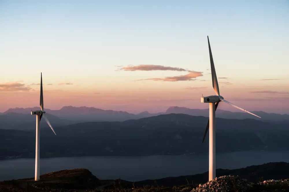 Wind turbines on a ridge at sunset